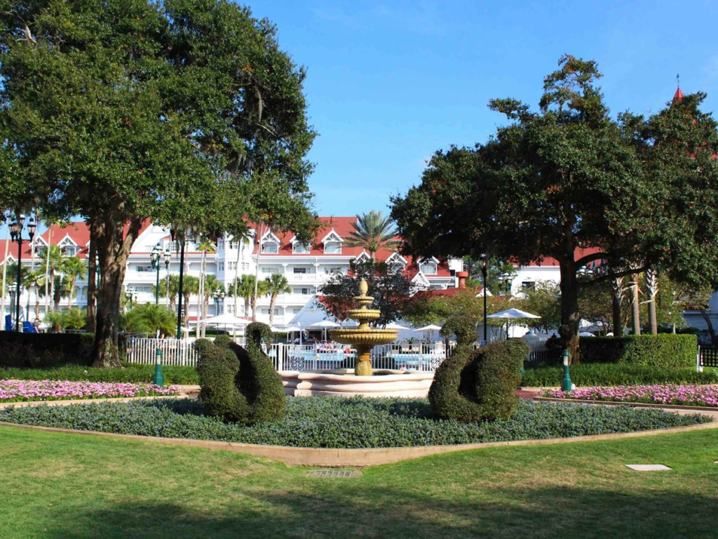 Swan-shaped topiaries and a tiered stone fountain in the courtyard garden of Disney's Grand Floridian.