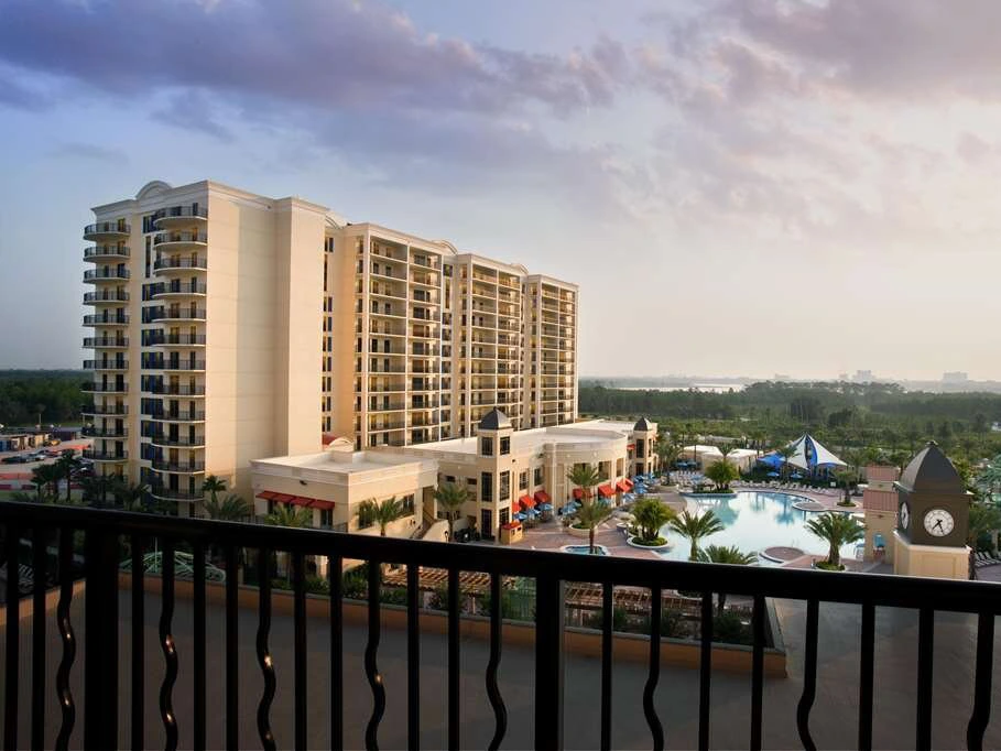 Aerial view of Hilton Grand Vacations Club Parc Soleil resort towers, pool deck, and clock tower.