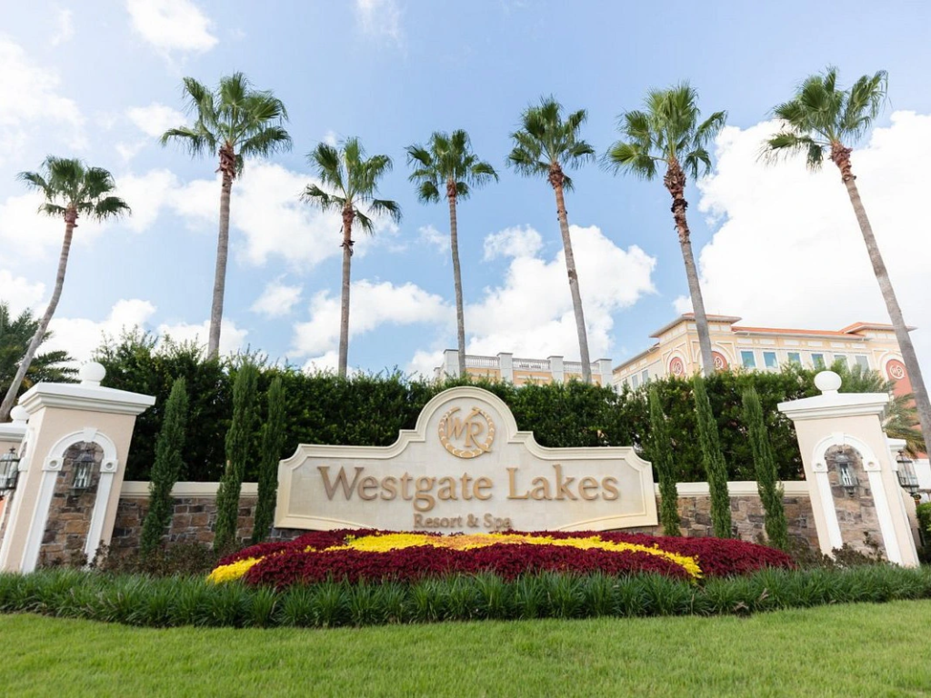 Entrance sign and tall palm trees at Westgate Lakes Resort and Spa reflecting timeshare values over time.