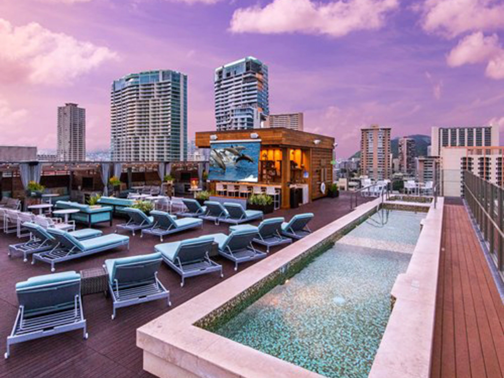 Luxury rooftop deck pool and lounge chairs at Hokulani Waikiki. Review Hilton timeshare financing details.