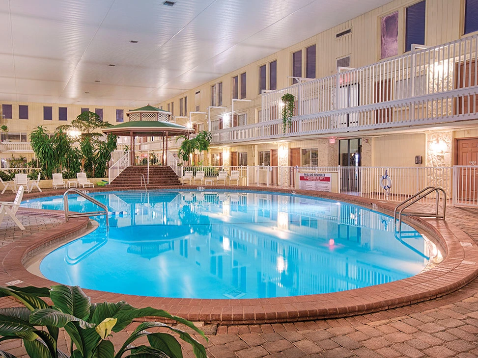 Sell Wyndham Points - indoor pool surrounded by plants and chairs, with a gazebo at one end.
