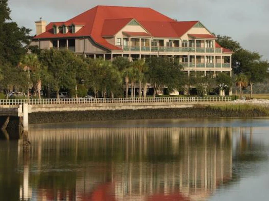 The iconic red-roofed exterior of Disney's Hilton Head Island Resort, a premier coastal vacation destination overlooking the marsh.