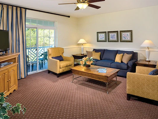 Cozy living room with seating and patio access at Club Wyndham Governor's Green.