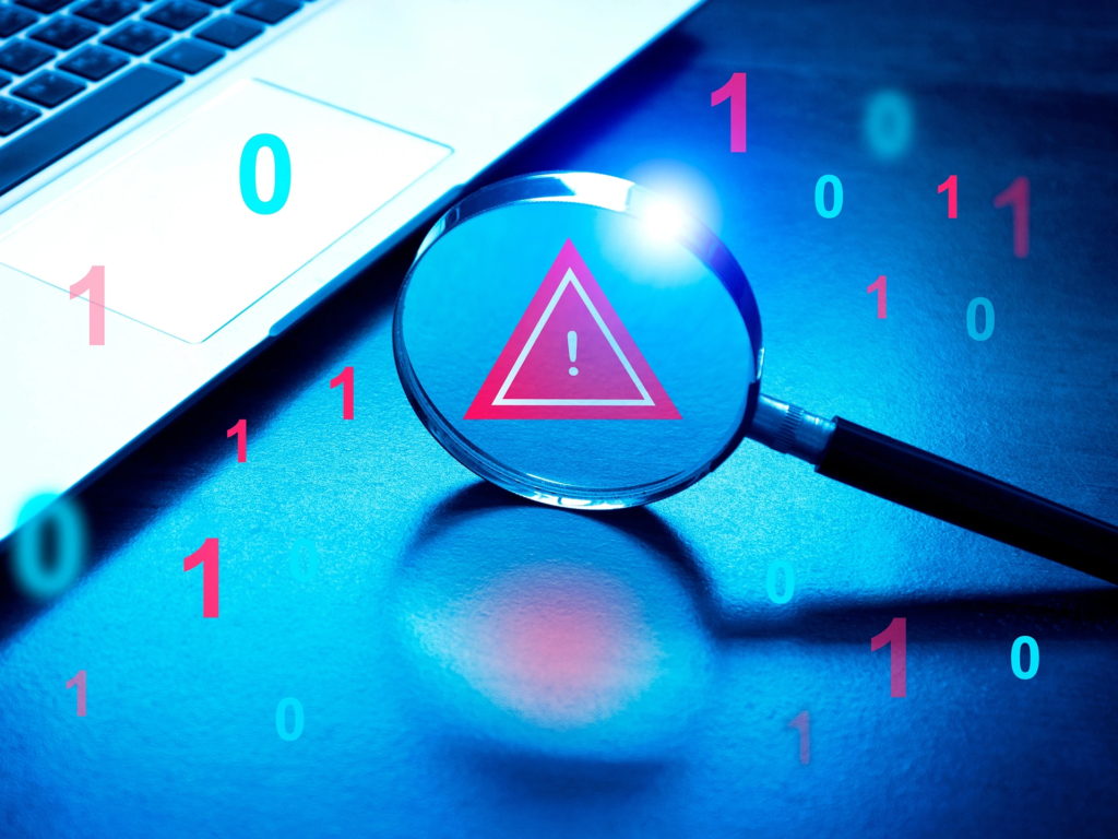 Magnifying glass showing a red scam alert warning triangle amidst floating binary code next to a laptop, symbolizing cybersecurity and digital fraud detection.