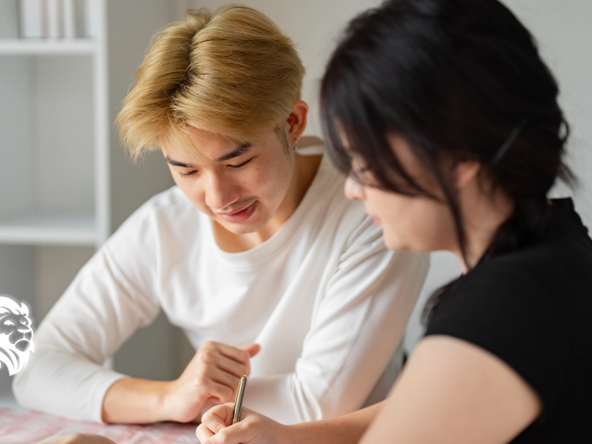A young couple signing paperwork after researching what documents do i need to sell my timeshare.