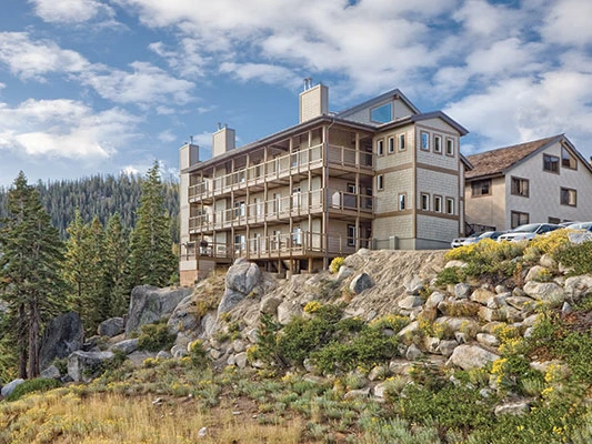 Multi-story wooden resort buildings on a rocky hillside at WorldMark Lake Tahoe, a factor in Club Wyndham vs WorldMark.Multi-story wooden resort buildings on a rocky hillside at WorldMark Lake Tahoe, a factor in Club Wyndham vs WorldMark.