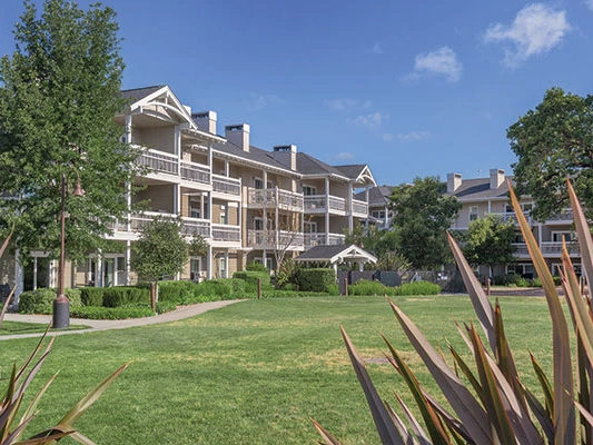 Exterior of the three-story resort buildings and grassy courtyard at WorldMark Windsor.