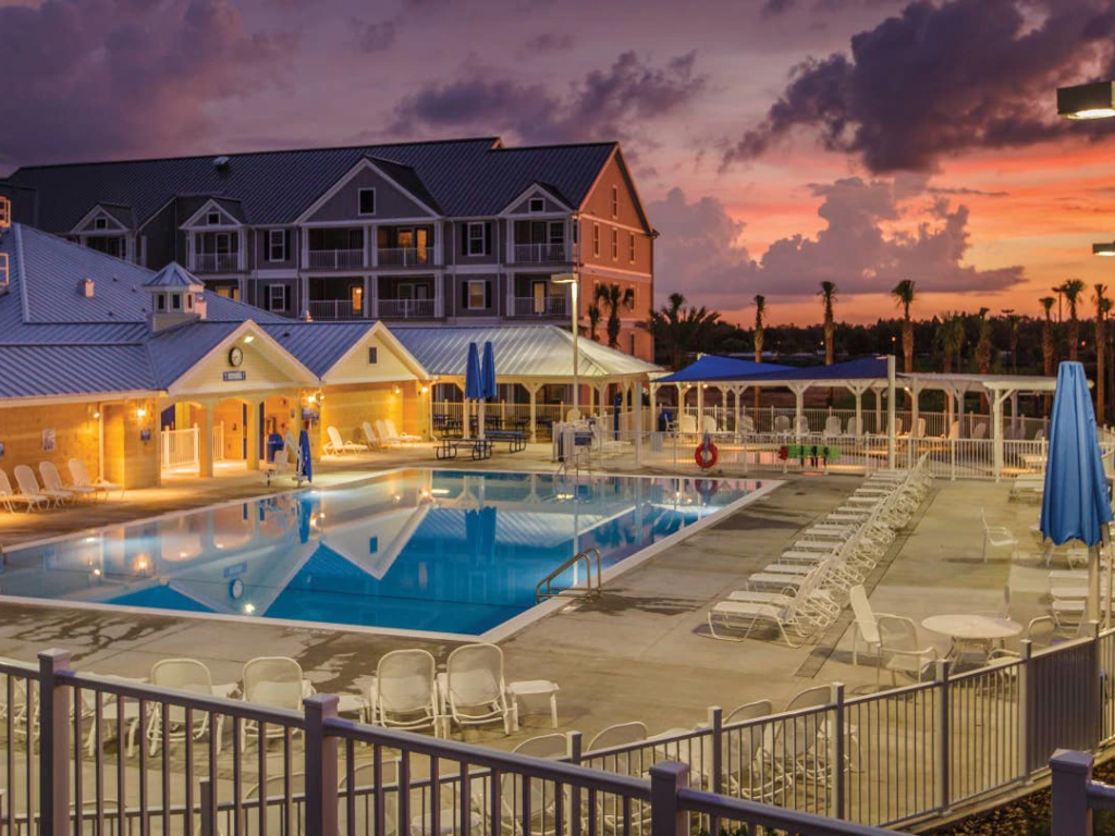 Sunset view of the expansive outdoor swimming pool at Orlando Breeze Resort, often featured on the best place to sell timeshare online.