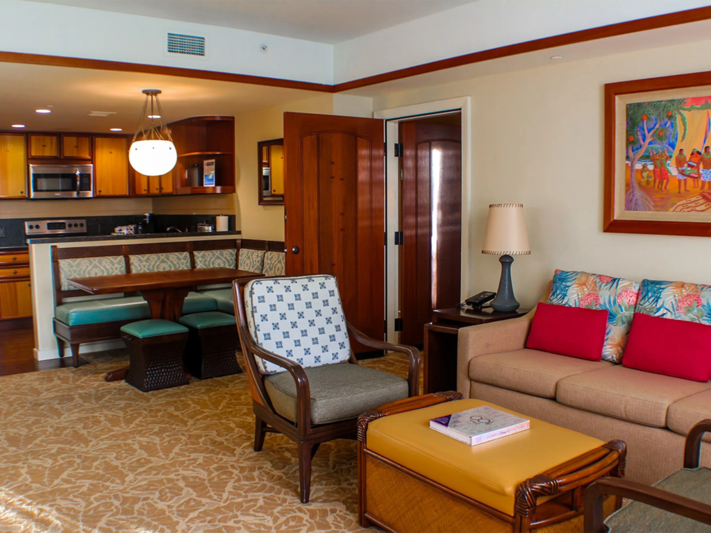 Open-concept living room and kitchen area inside an aulani disney vacation club villas multi-bedroom suite.