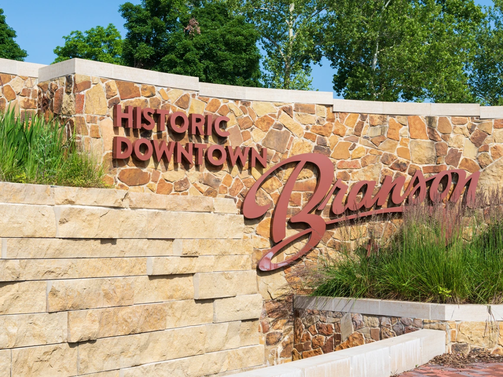 A stone wall monument marking the entrance to Historic Downtown Branson.