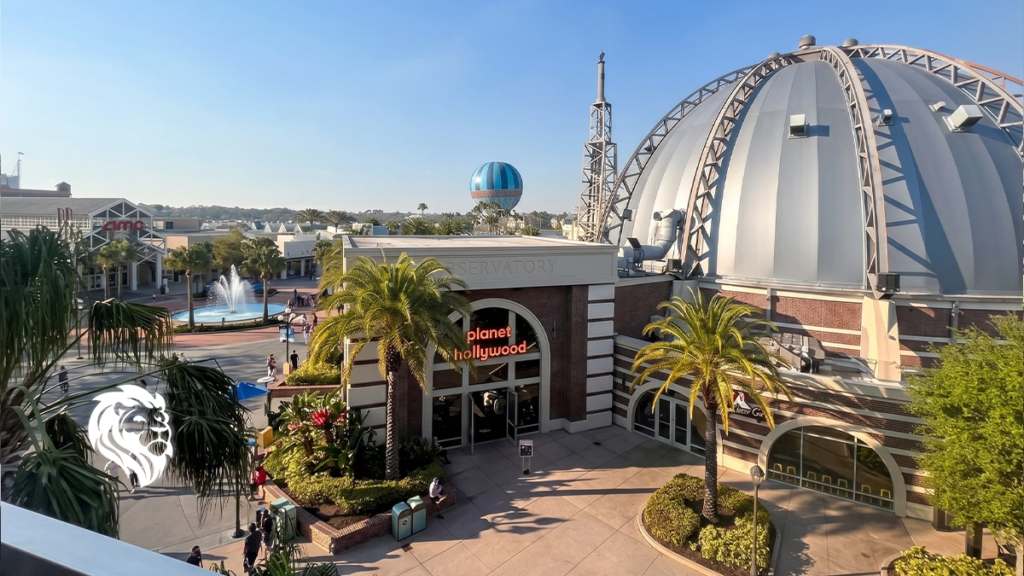 Exterior view of the domed Planet Hollywood restaurant and walking paths at Disney Springs.