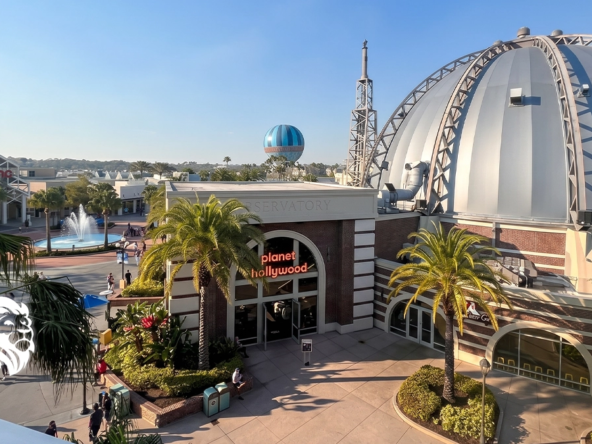 Exterior view of the domed Planet Hollywood restaurant and walking paths at Disney Springs.