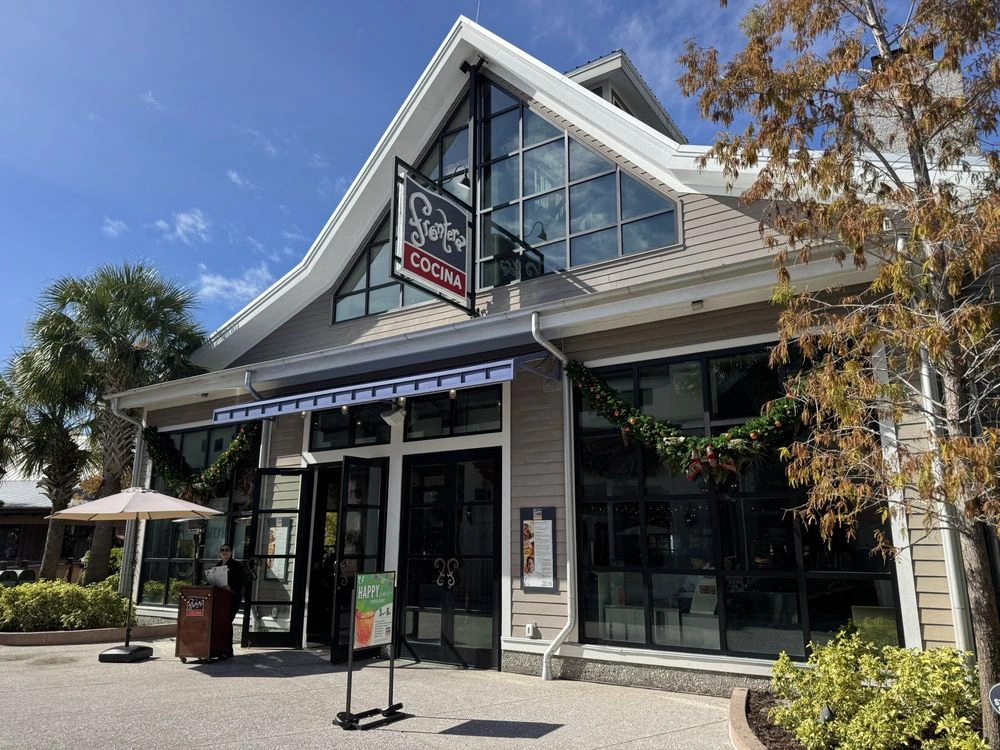 The modern angled roof and sunlit exterior of Frontera Cocina restaurant at Disney Springs.