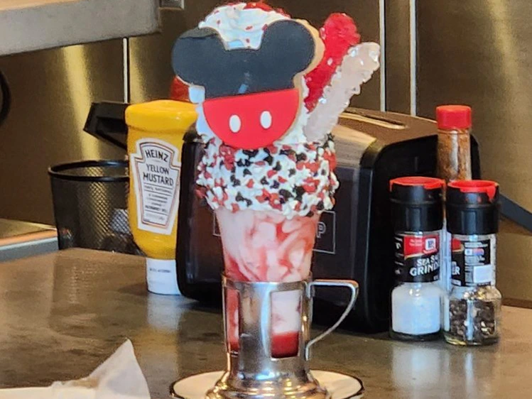 Elaborate Mickey Mouse strawberry shake with whipped cream, a sweet highlight among the Best Downtown Disney Restaurants.