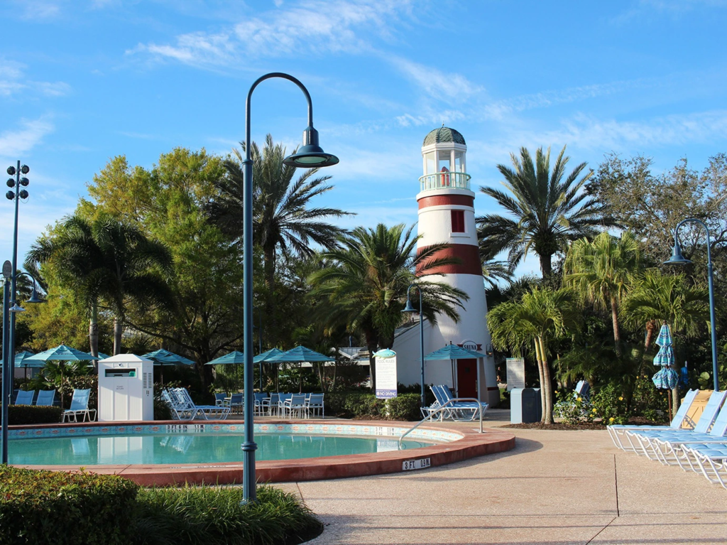 A red and white lighthouse by the pool at Disney's Old Key West Resort, where disney vacation club maintenance fees apply.
