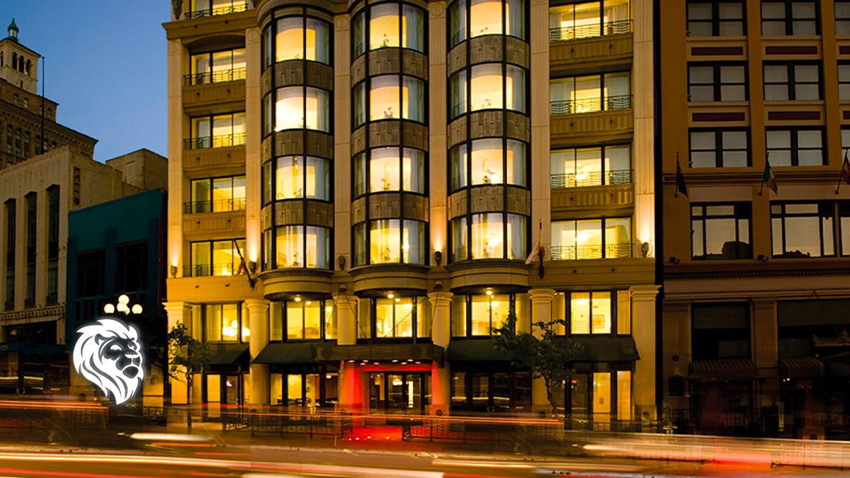 Illuminated exterior of Club Wyndham Harbour Lights at night featuring rounded bay windows and car light trails.