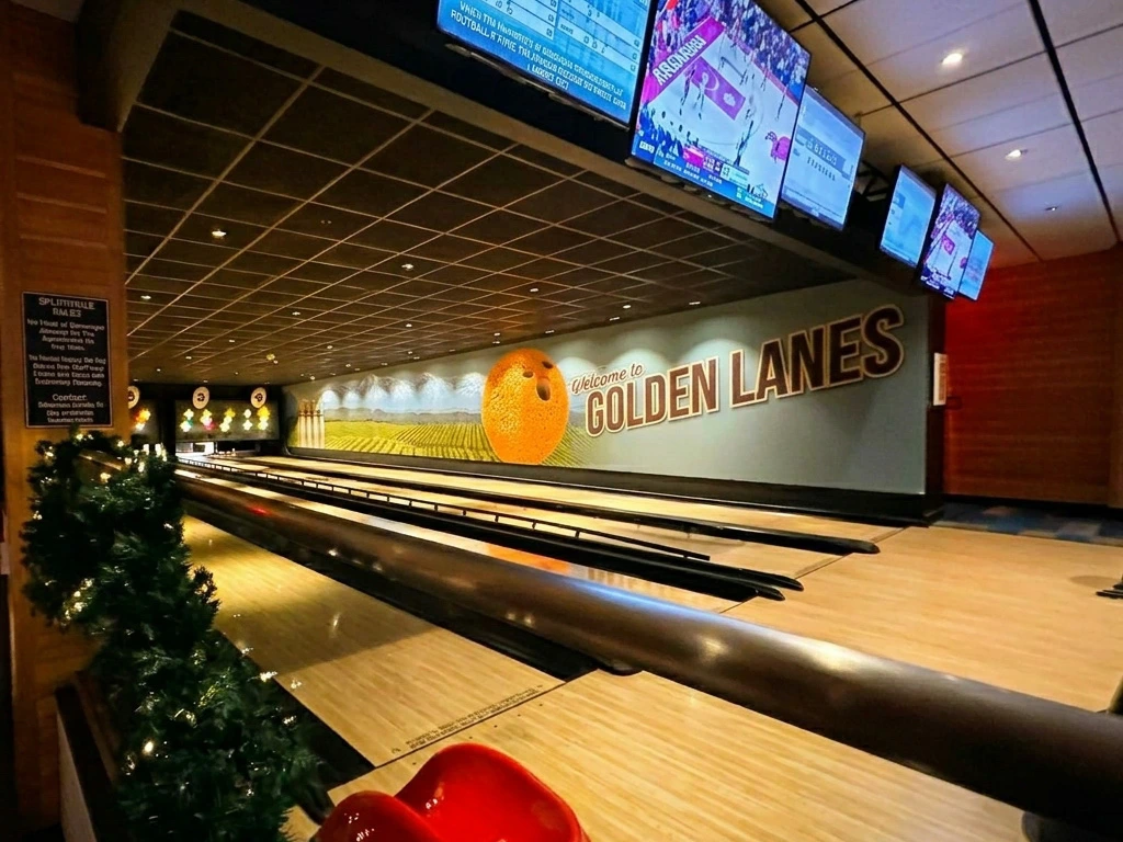Polished bowling lanes and a vintage orange grove mural at Splitsville, one of the Best Downtown Disney Restaurants.