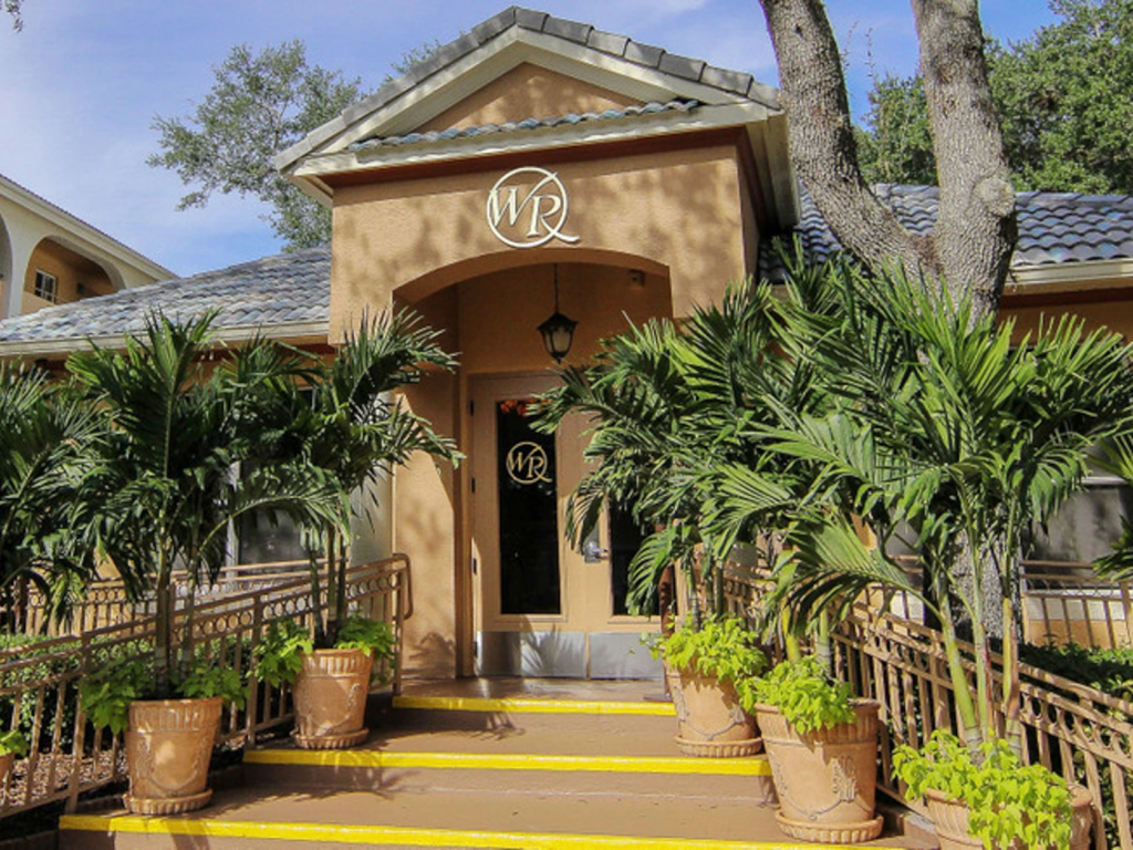 Potted palms line the entrance stairs at Westgate Leisure Resort, an ideal option for westgate timeshare resale value.