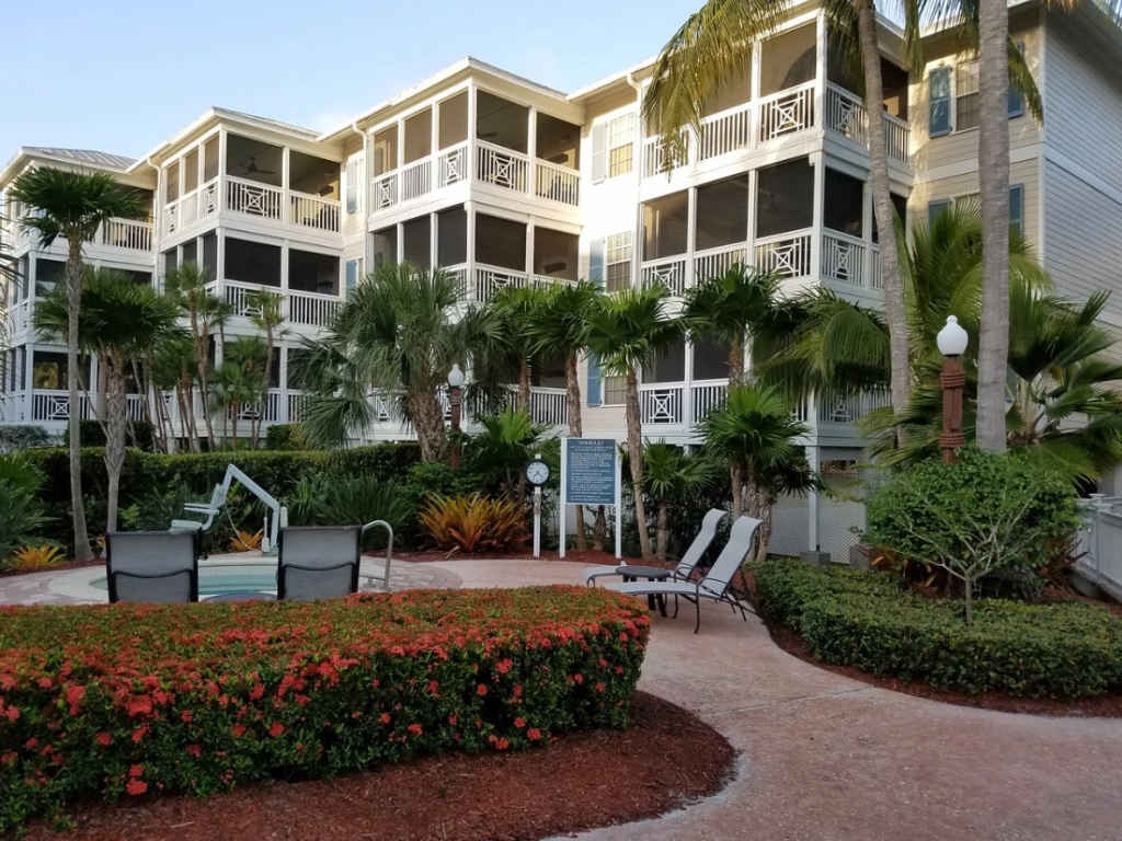 Screened balconies, lush tropical landscaping, and patio lounge chairs at Hyatt Beach House Resort in Key West.