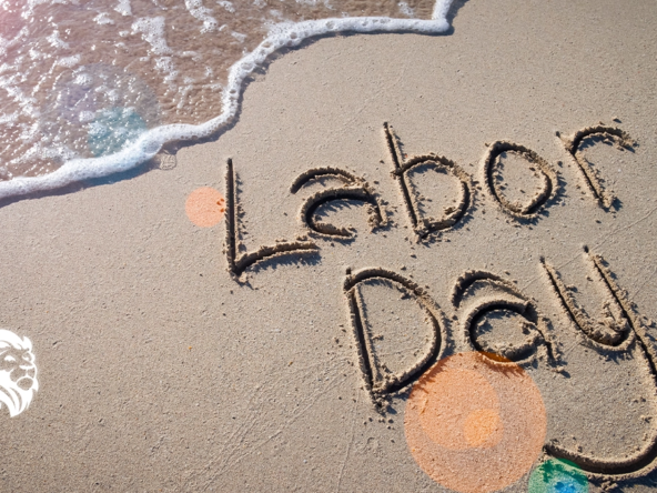 The words Labor Day written in the sand, capturing the essence of labor day travel.