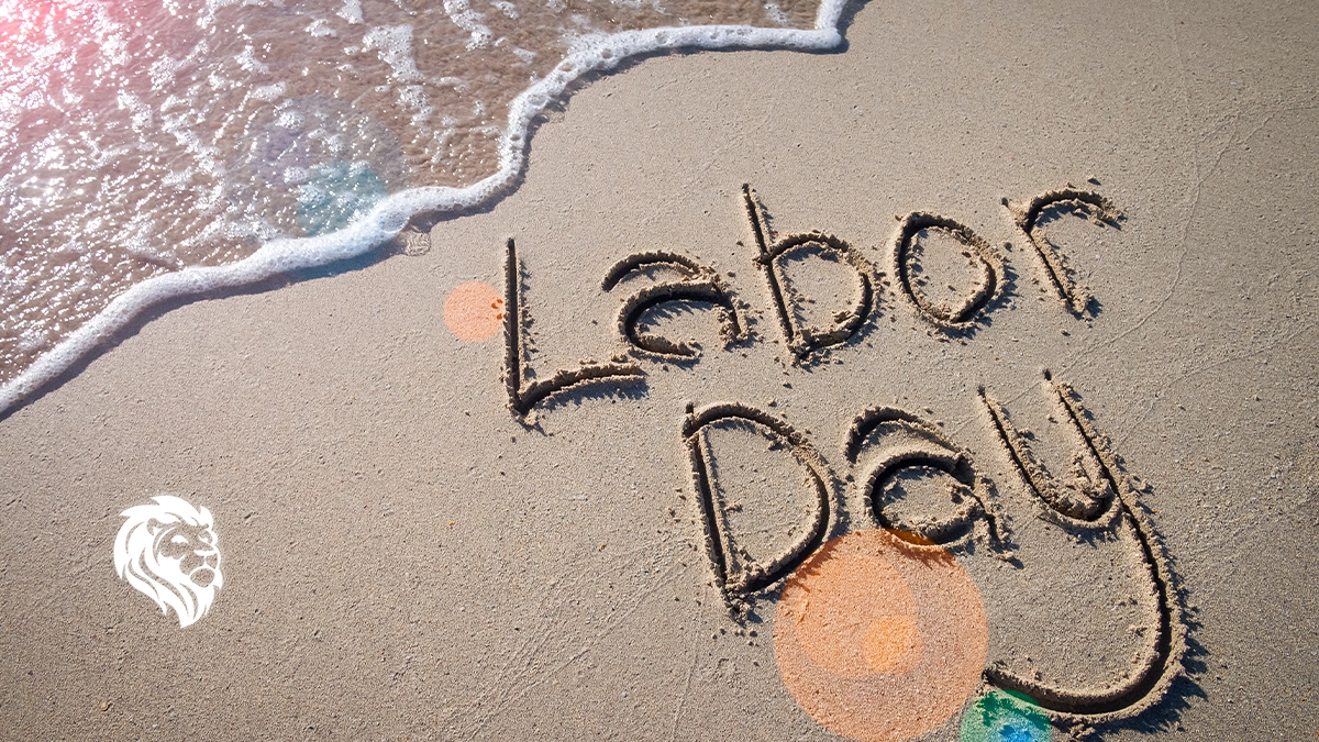 The words Labor Day written in the sand, capturing the essence of labor day travel.