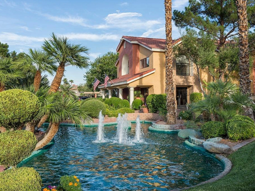 A landscaped pond fountain and palm trees at Westgate Flamingo Bay Resort, showcasing westgate timeshare resale value.